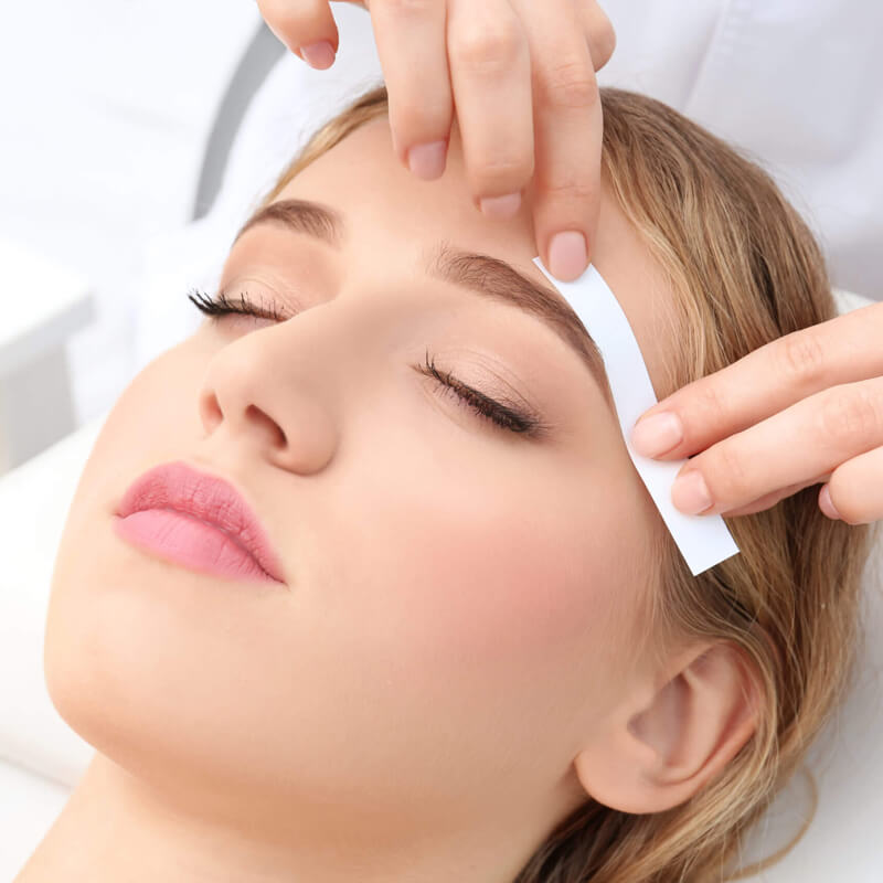 Premium Photo  Eyebrow correction with wax in a beauty salon eyebrow hair  removal with wax